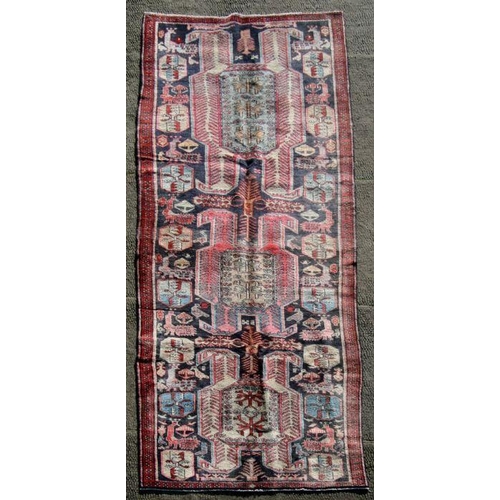 107 - A Persian Azari woollen hand knotted runner, on a beige ground, 320 by 110cms (376).