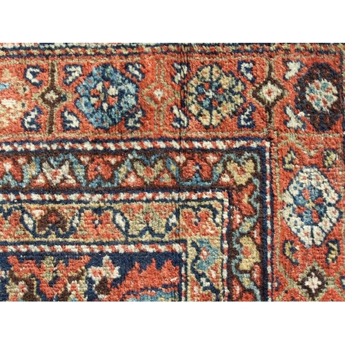 114 - A Persian Kellah runner with repeating geometric pattern on a red ground, 472 by 174cms.