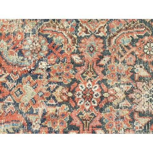 114 - A Persian Kellah runner with repeating geometric pattern on a red ground, 472 by 174cms.