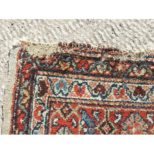 114 - A Persian Kellah runner with repeating geometric pattern on a red ground, 472 by 174cms.