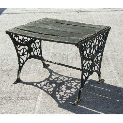 15 - A garden table with pierced cast ends, 91cms wide.