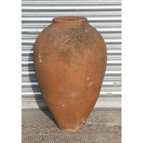 19 - A large terracotta olive jar, approx 63cms high.