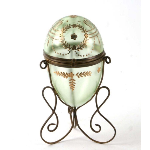 240 - A late 19th century Palais Royale style egg shaped green glass box on gilt metal stand, 17cms high.