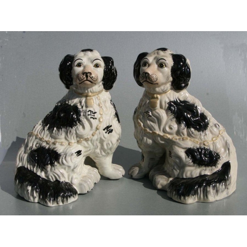 269 - A pair of Staffordshire style seated spaniels, 27cms high.