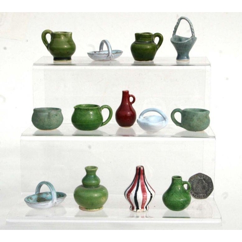 291 - A quantity of Rye Pottery miniature jugs, vases and baskets.