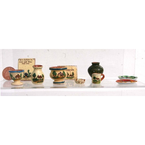 292 - A quantity of miniature doll's house ceramics to include Watcombe Motto ware and Rye Pottery items.