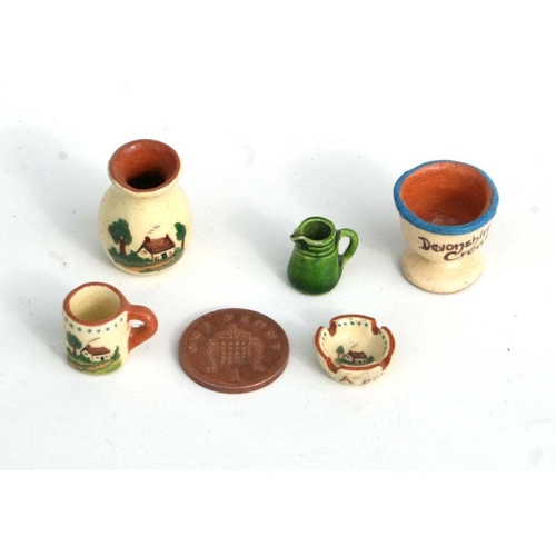 292 - A quantity of miniature doll's house ceramics to include Watcombe Motto ware and Rye Pottery items.