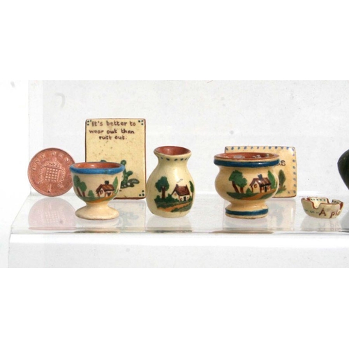 292 - A quantity of miniature doll's house ceramics to include Watcombe Motto ware and Rye Pottery items.