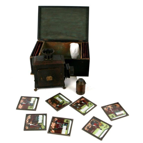 303 - A late 19th century German tin table top Magic Lantern in original box; together with a box of magic... 