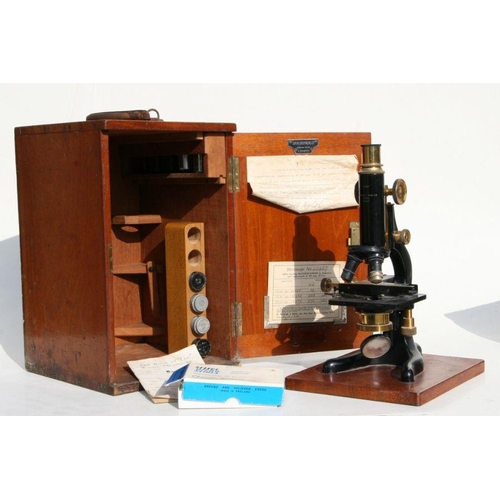 304 - A Dakin Bros. Ltd London black lacquered and brass microscope with various lenses and slides, in a f... 