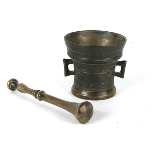 327 - A 17th century style bronze mortar and pestle, 12cms high.