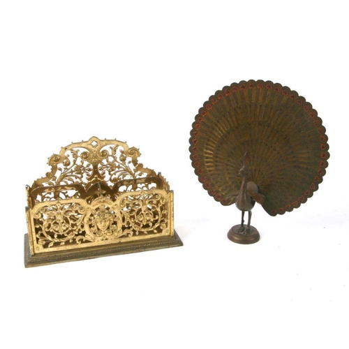 339 - A gilt brass letter rack, 28cms wide; together with an Indian brass peacock, 29cms high (2).