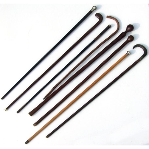 350 - Eight vintage walking sticks including a silver topped example and ethnic clubs