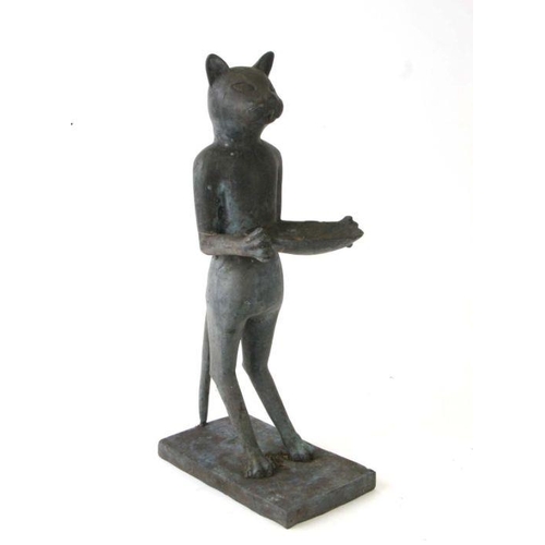 372 - A patenated brass / bronze figure of a standing cat holding a shallow bowl, 50cms high.