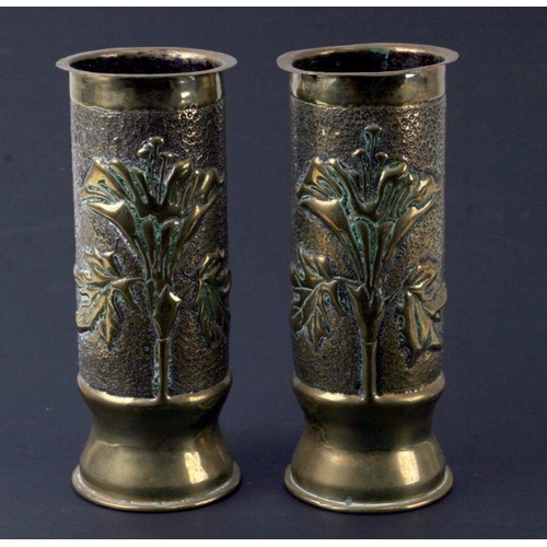 40 - A pair of WWI trench art shell cases decorated with flowers, 23cms high.