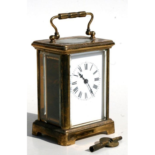 411 - A carriage clock, the white porcelain dial with Roman numerals, in a gilt brass four-pillar case, 8c... 