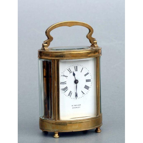 414 - A brass cased carriage time piece, the white enamel dial with Roman numerals, 13cms high.