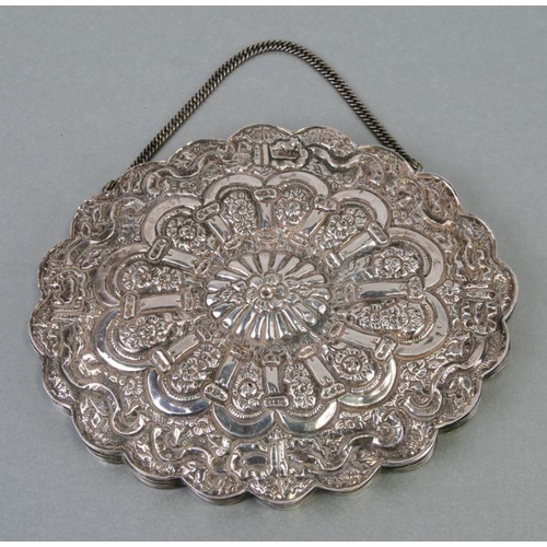 456 - A Persian 900 grade silver oval wedding mirror with wavy rim and repousse decoration, 16cms wide.