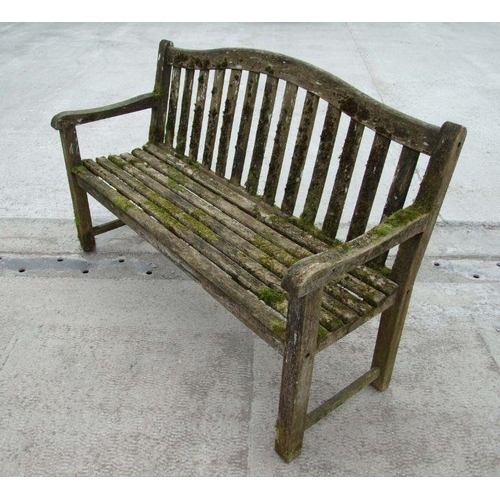 5 - An Alexander Rose well weathered teak garden bench, 149cms wide.