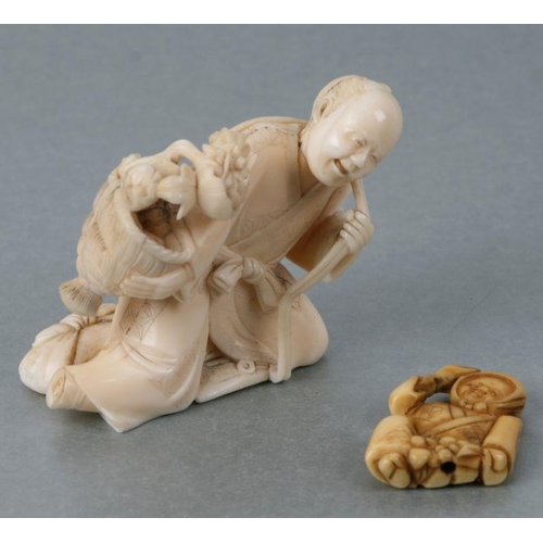 537 - A Japanese carved ivory figure of a fruit seller, 6cms wide; together with a Japanese carved ivory n... 