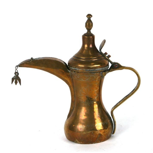 539 - A Turkish / Islamic brass dallah coffee pot with engraved decoration, 24cms high.