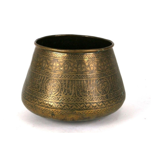 543 - An Islamic brass palm pot decorated with foliate scrolls and calligraphy, 19cms high.