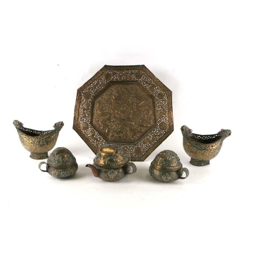 547 - A group of Tibetan brass items to include an octagonal tray, a three-piece tease and a pair of kashk... 