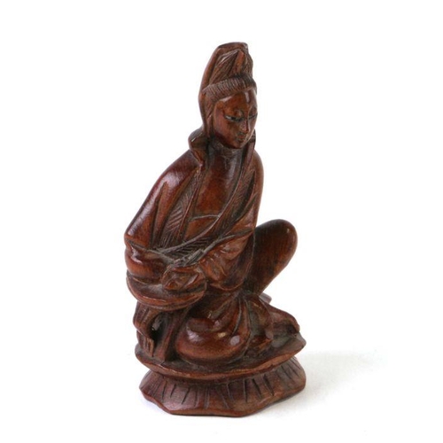 562 - A Chinese hardwood figure depicting Guanyin, 9cms high.