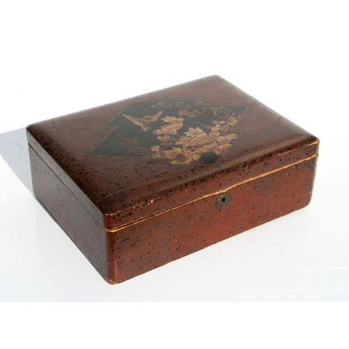 570 - A Japanese lacquer box decorated with a gilded bird and flowers, 31cms wide.