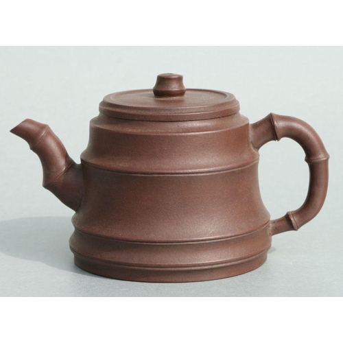 583 - A Chinese Yixing pottery teapot with stylised bamboo spout and handle, impressed seal mark to the un... 