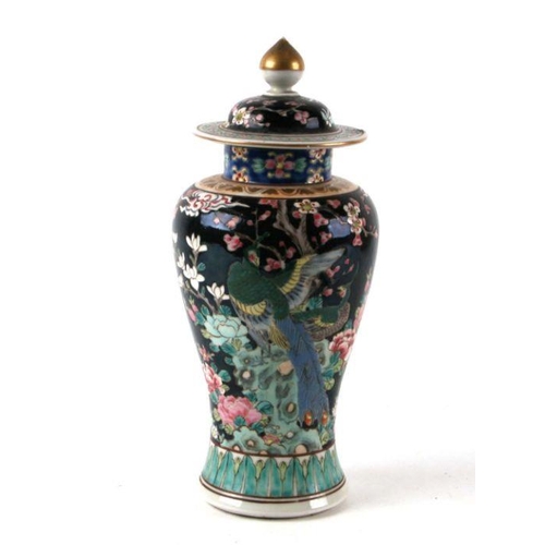 590 - A Chinese famille noir baluster vase and cover decorated with birds and flowers, 26cms high.