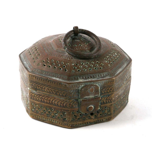 594 - An Indian pierced brass four-division spice box of octagonal form, 14cms wide.