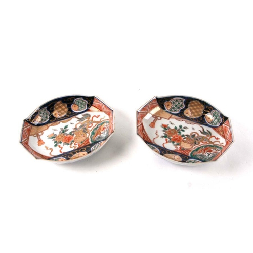 595 - A pair of Chinese Imari shallow dishes decorated with shishi and flowers in the typical Imari palate... 