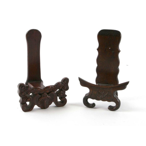 596 - Two Chinese hardwood plate stands, the largest 18cms high (2).