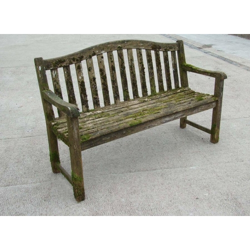 6 - An Alexander Rose well weathered teak garden bench, 149cms wide.