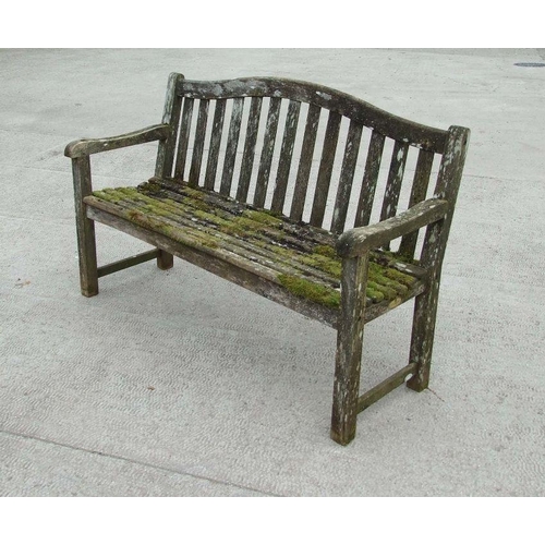 6 - An Alexander Rose well weathered teak garden bench, 149cms wide.