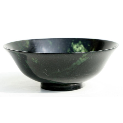 607 - A figured jade / hardstone footed bowl, 13.5cms diameter.