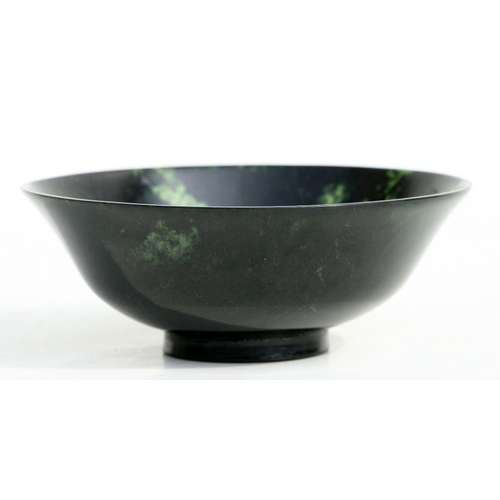 607 - A figured jade / hardstone footed bowl, 13.5cms diameter.