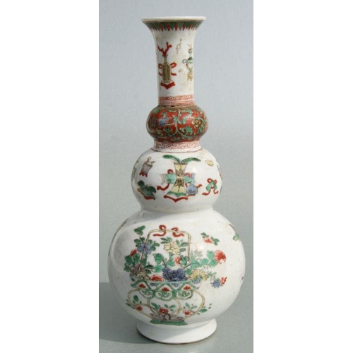 617 - A Chinese Kangxi famille rose triple gourd vase decorated with precious objects, 26cms high.