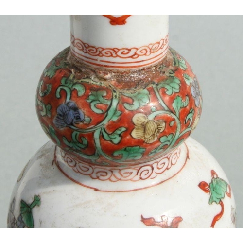 617 - A Chinese Kangxi famille rose triple gourd vase decorated with precious objects, 26cms high.