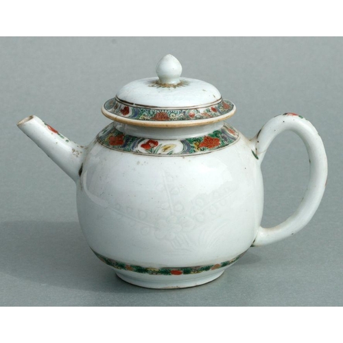 619 - A Chinese famille rose teapot of globular form, decorated with sgraffito and flowers, 11cms high.