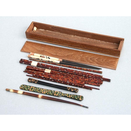 621 - A group of lacquer and bone chopsticks in a hardwood case.