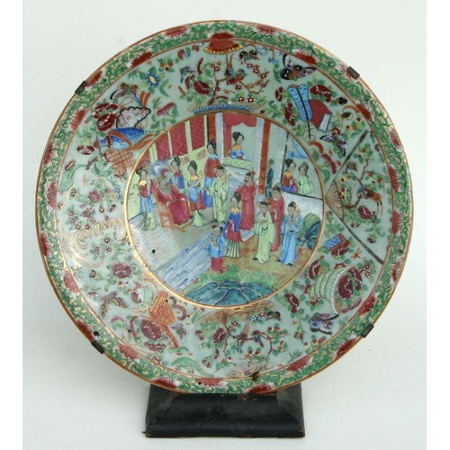 632 - A Chinese Canton export famille rose charger decorated with figures in a court scene within a foliat... 