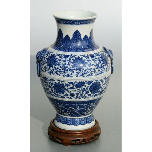 633 - A Chinese blue & white vase with elephant mask handles, decorated with foliate scrolls and waves, bl... 