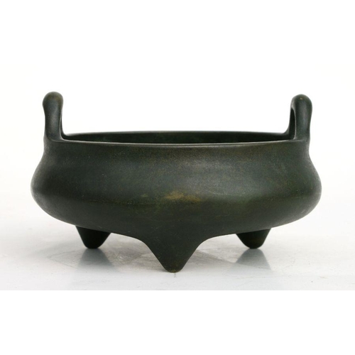 640 - A Chinese bronze two-handled censer on tripod legs, six character mark to the underside, 16cms diame... 