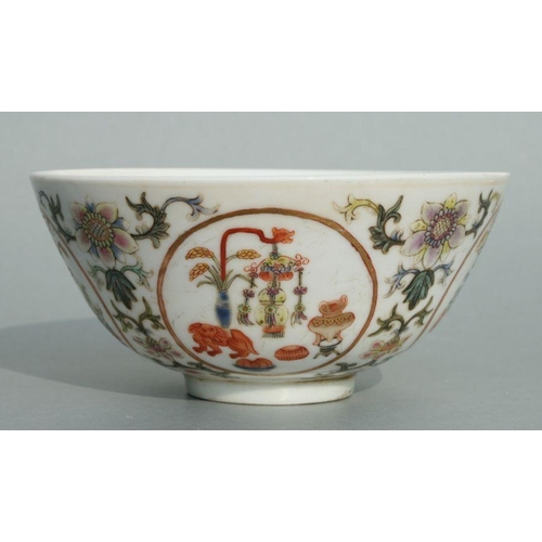 642 - A Chinese famille rose bowl decorated with precious objects within roundels and foliate scrolls, red... 