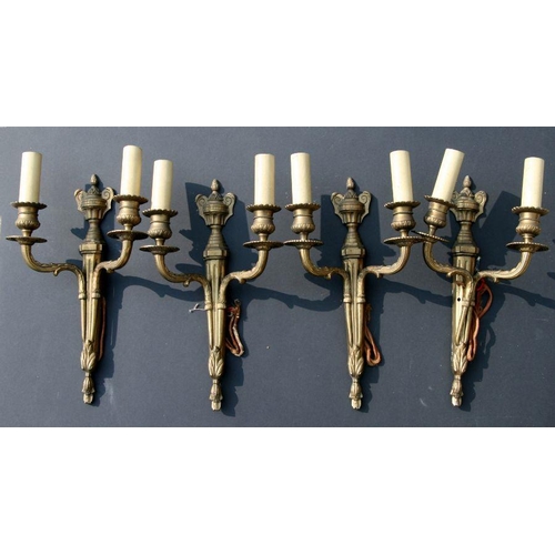 647 - A set of four twin arm brass wall lights, 35cms high.