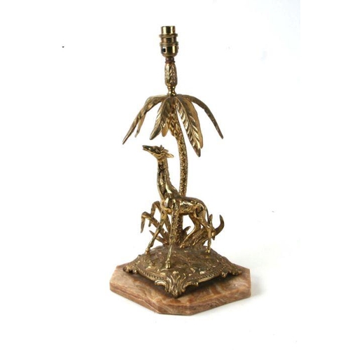 651 - A brass table lamp depicting a giraffe under a palm tree mounted on an alabaster plinth, 41cms high.