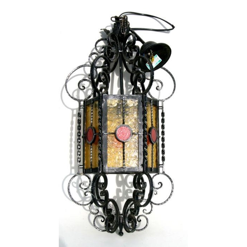 655 - A wrought iron and brass hall lantern of hexagonal form, 64cms high.