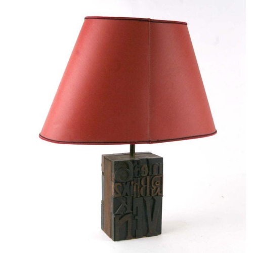 660 - An unusual table lamp made from printers blocks, numbers and letters, 30cms high.